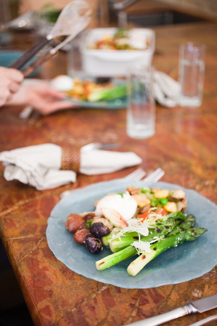 Plated Brunch Dish, Asparagus, Lobster Poached Egg, New Potatoes - with hands