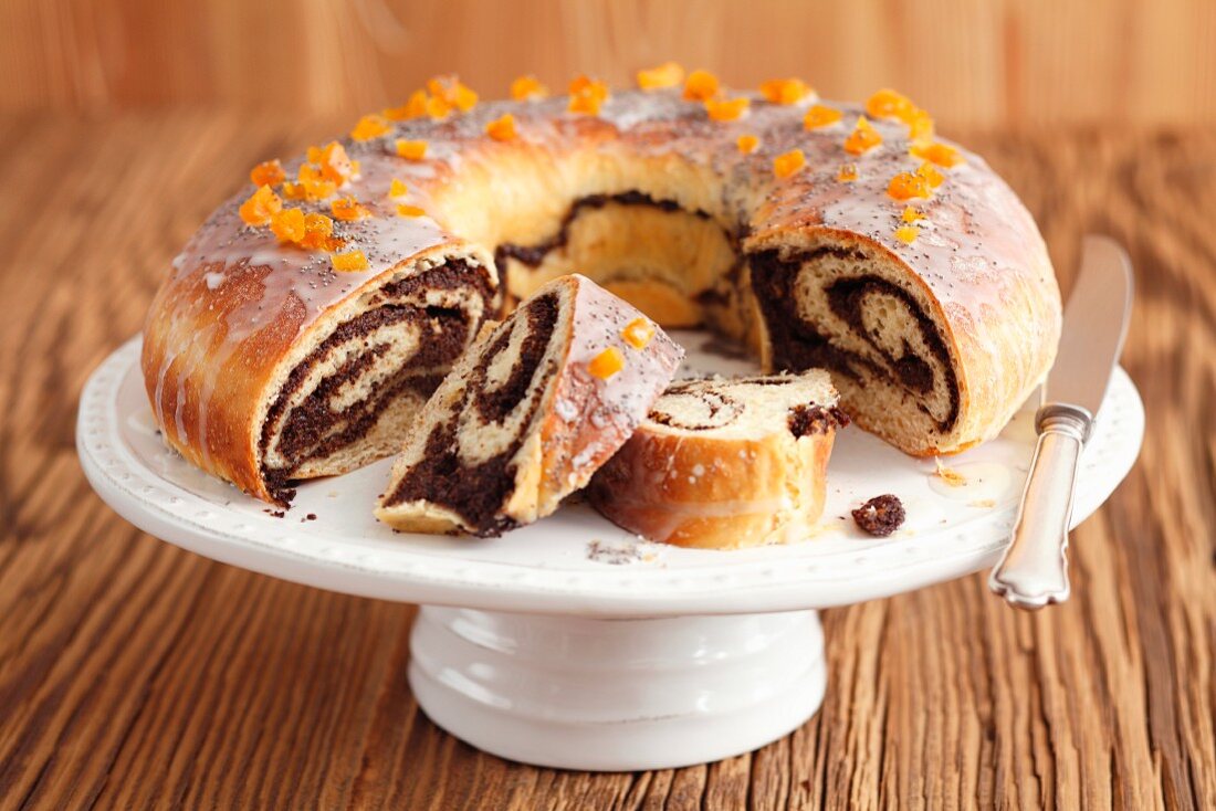 Poppy seed roulade, partly sliced, a cake stand