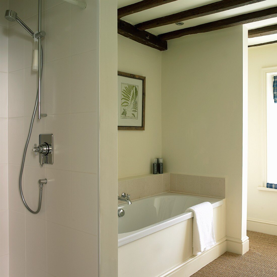Fitted bathtub and open shower in renovated half-timbered house