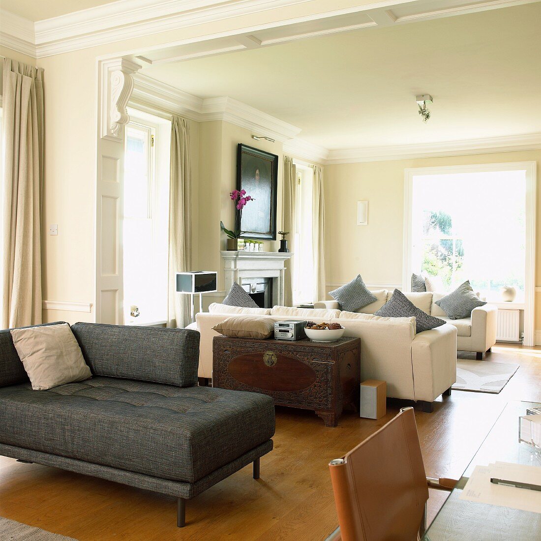 Sofas in long room with stucco ceiling
