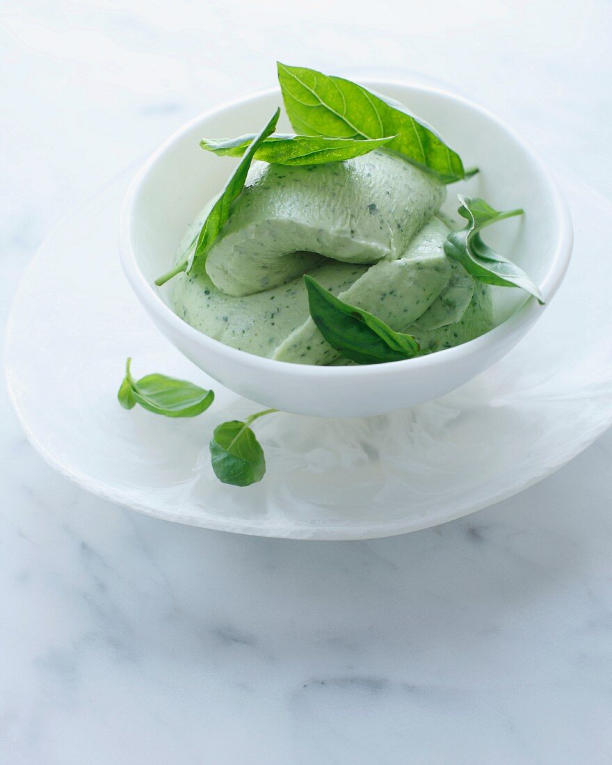 Bowl of basil ice cream with garnish