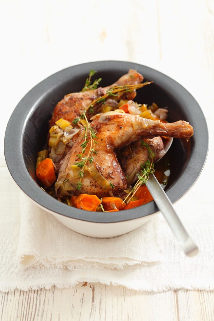 Chicken legs braised in wine, with carrots and thyme