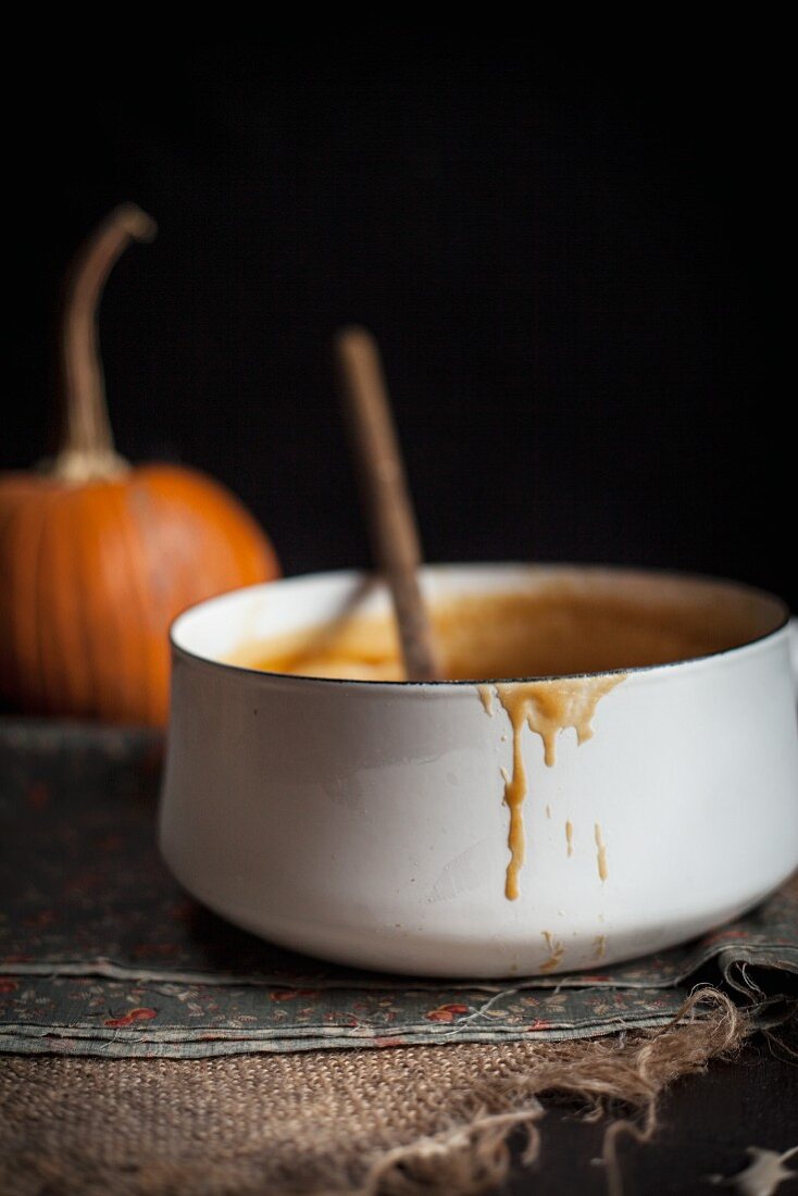 A Pot of Caramel with a Pumpkin in the background
