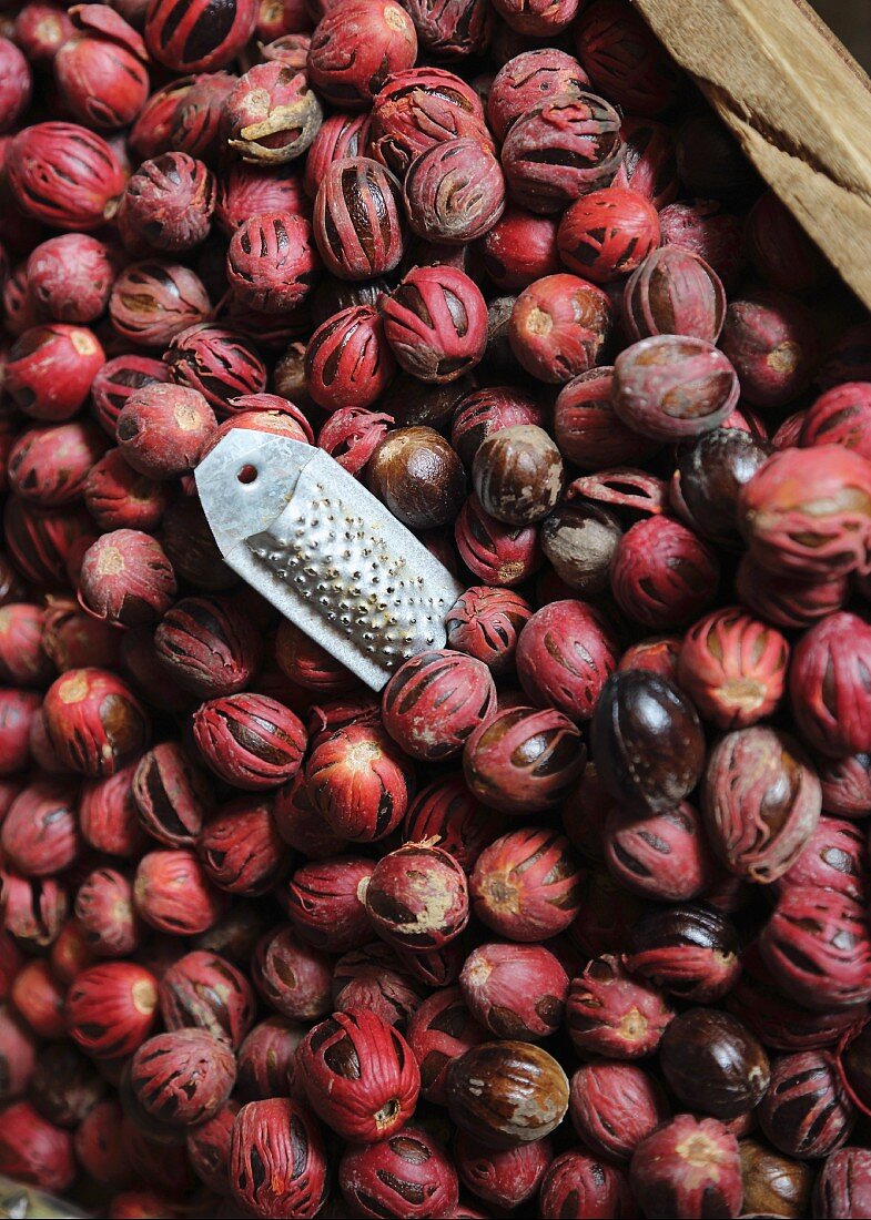 Fresh nutmegs and a grater