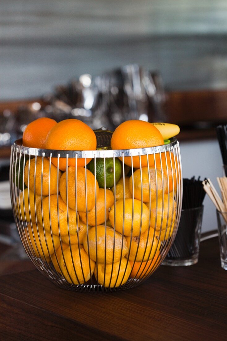 Mixed Citrus Fruit in a Wire Basket on a Bar