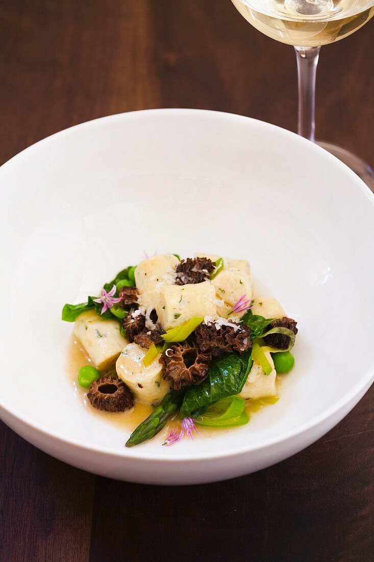 Gnocchi with Asparagus and Morel Mushrooms in a White Bowl