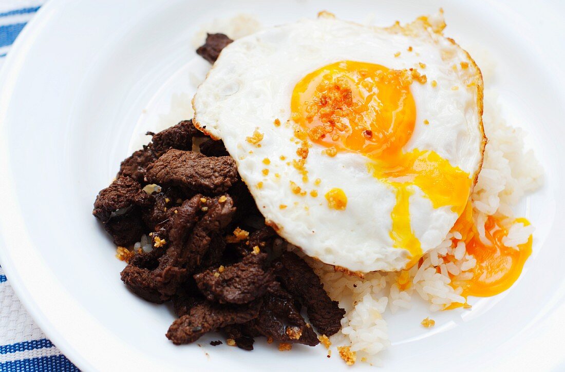 Tapsilog (beef with rice and fried egg - traditional breakfast dish in the Philippines)