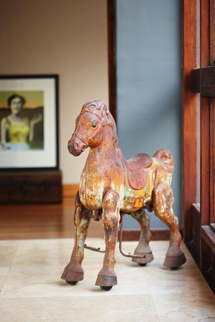 Horse figure in front of wood-framed window