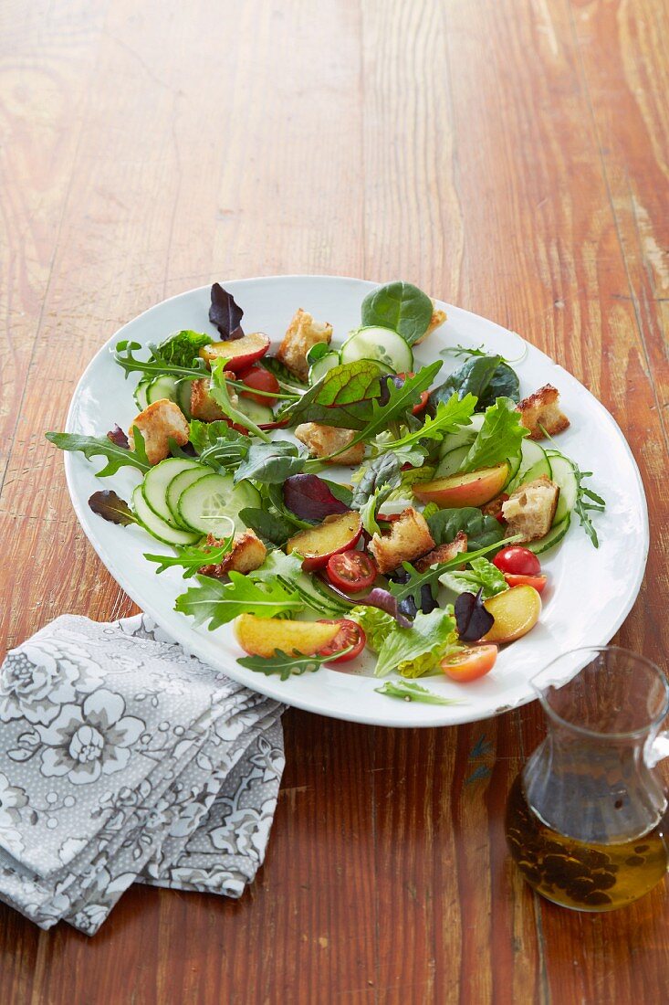 A party salad with apple and croutons
