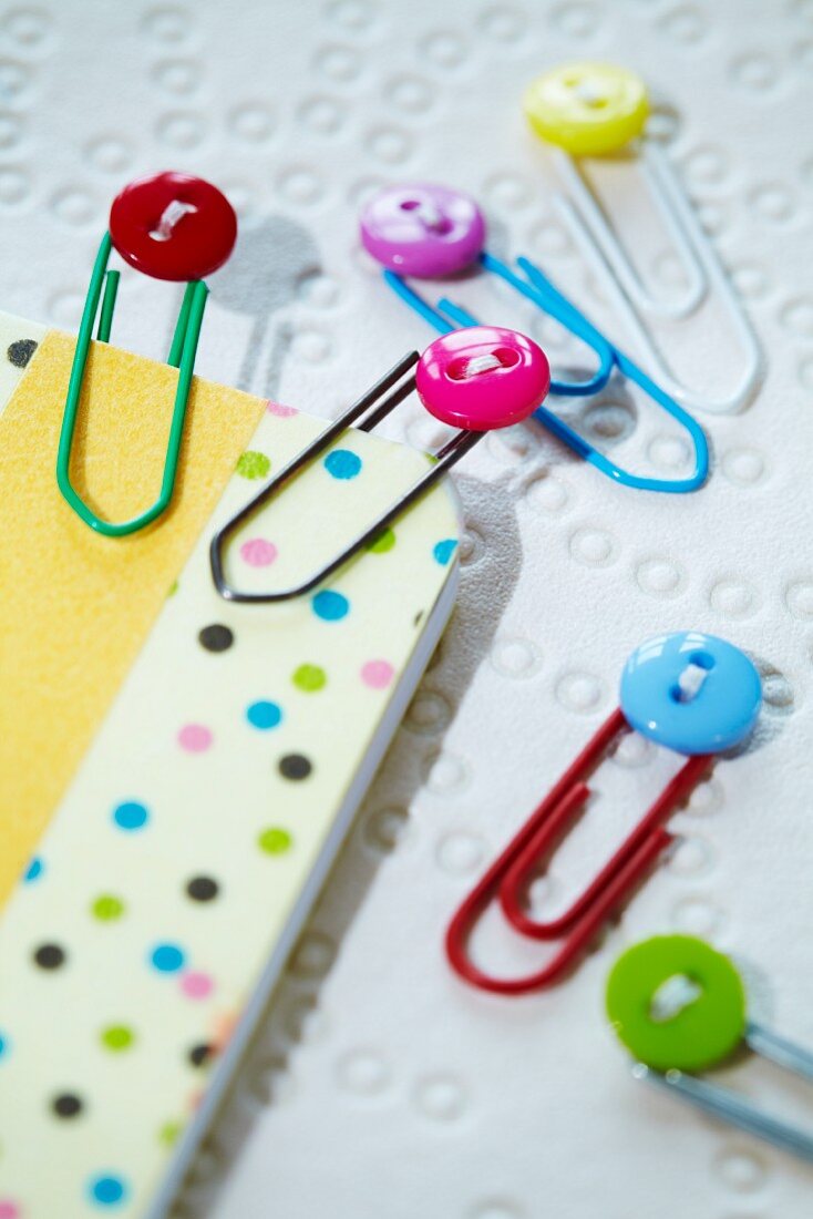 Colourful miniature buttons decorating paperclips