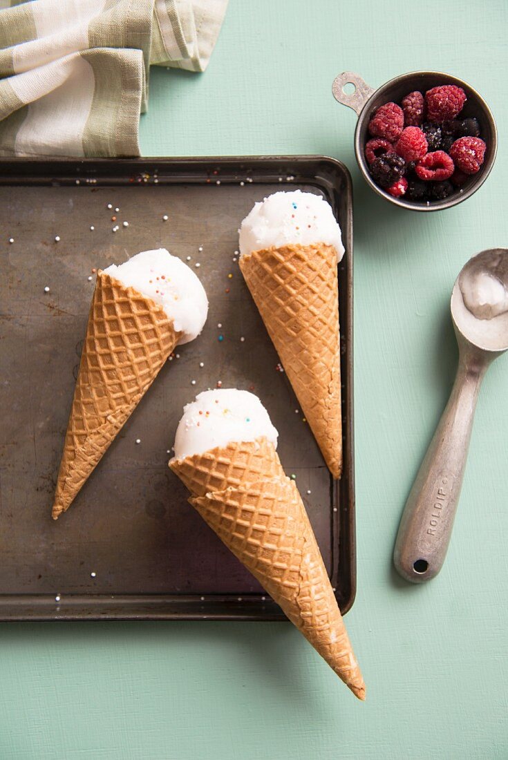 Three ice cream cones and fresh berries