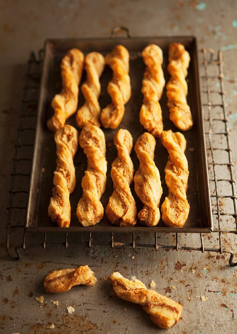Freshly baked cheese straws on a baking tray
