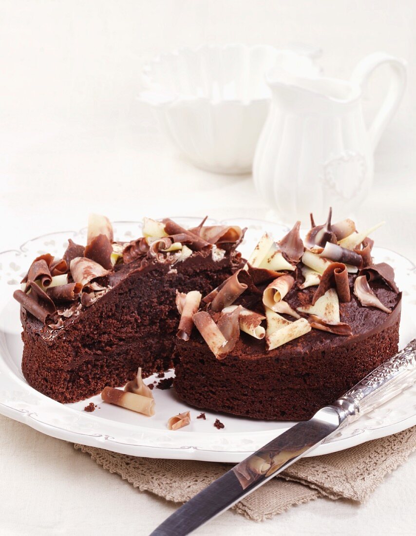 Chocolate cake with chocolate curls, cut in half