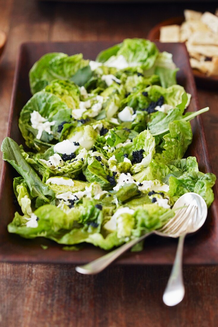 Green salad with curd cheese and caviar