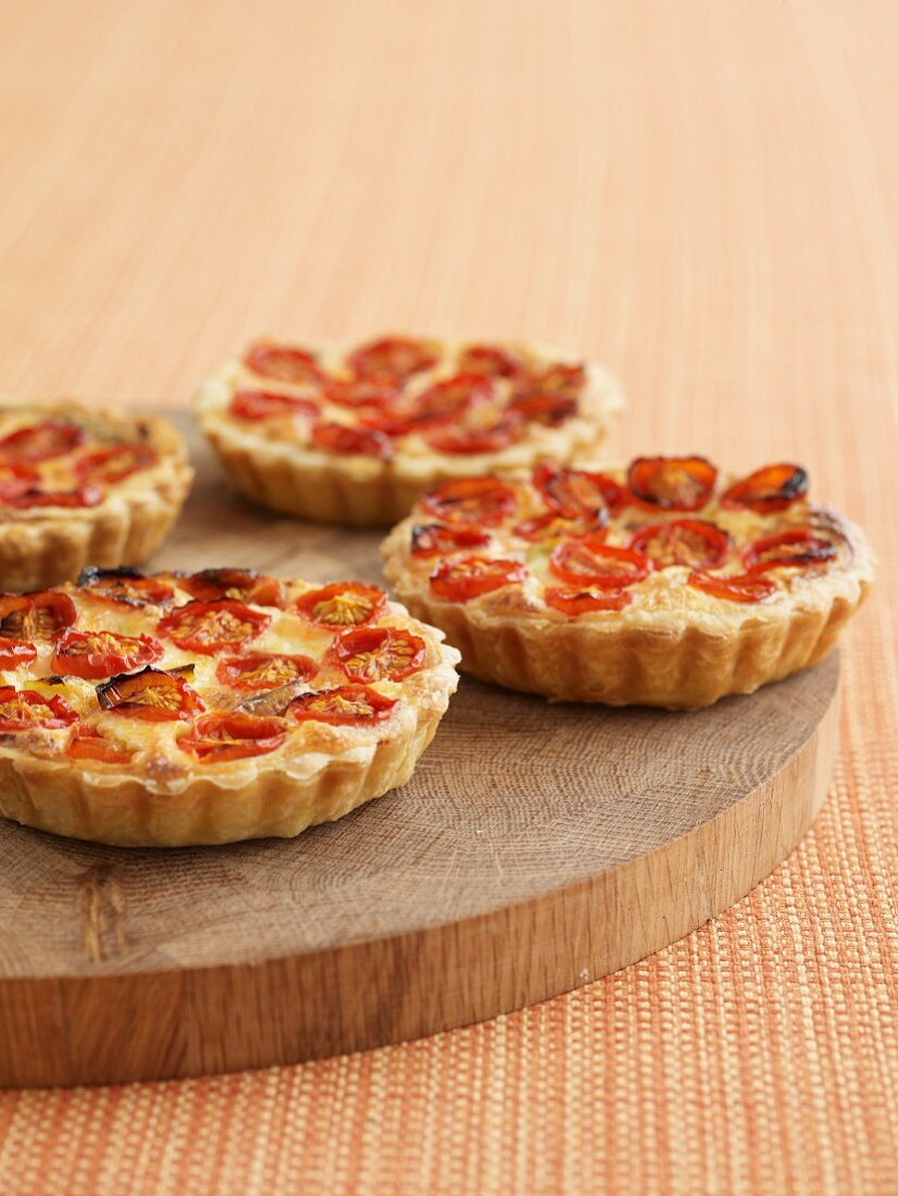 Tomato tartlets on a wooden board