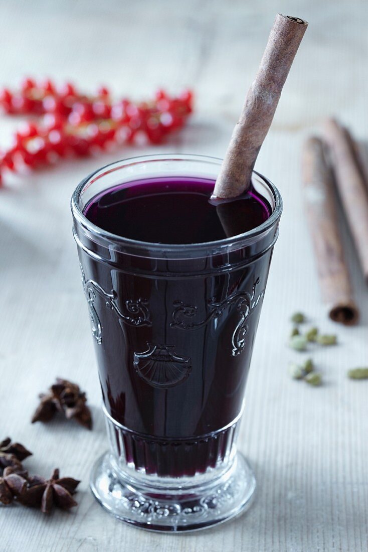 Mulled wine in a glass with a cinnamon stick