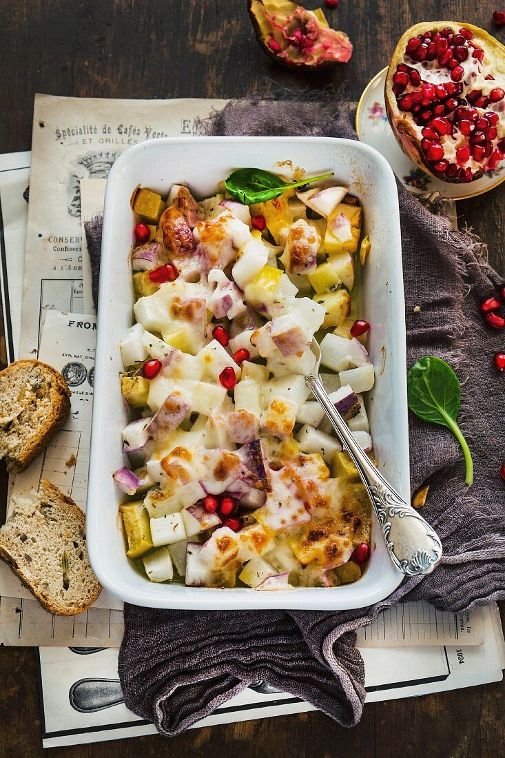 Cheese-topped turnip bake with pomegranate seeds