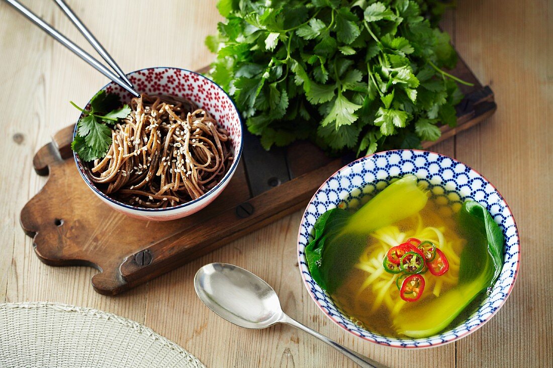 Pasta with sesame seeds and noodle soup with bok choy (Asia)