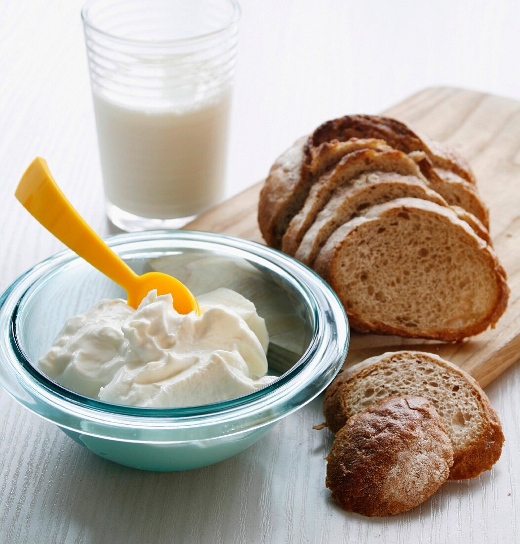 Quark in a glass bowl with bread and milk