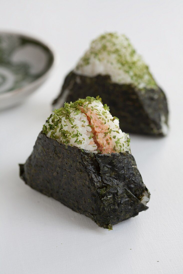 Onigiri in sheets of nori (spiced rice balls, Japan) with salmon filling