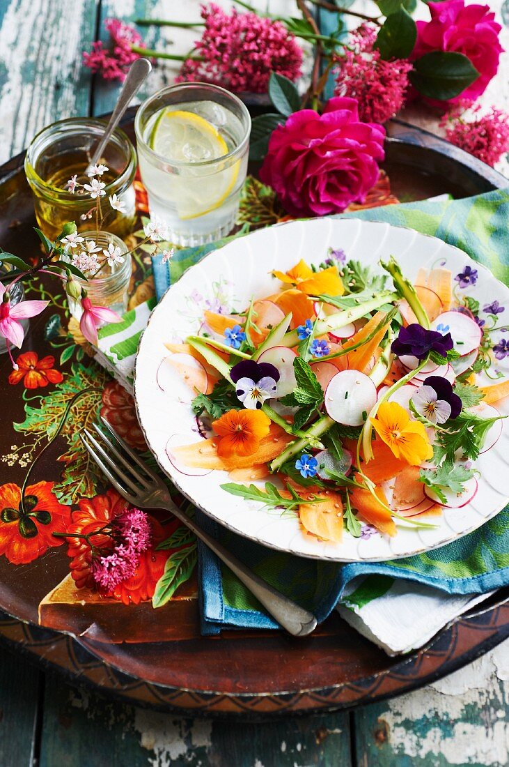 Colourful vegetable salad with radishes and edible flowers