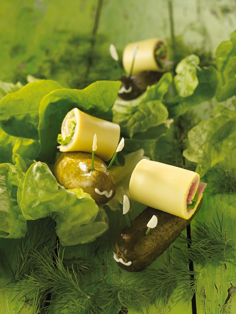 Snails made from pickled gherkins with rolled cheese shells
