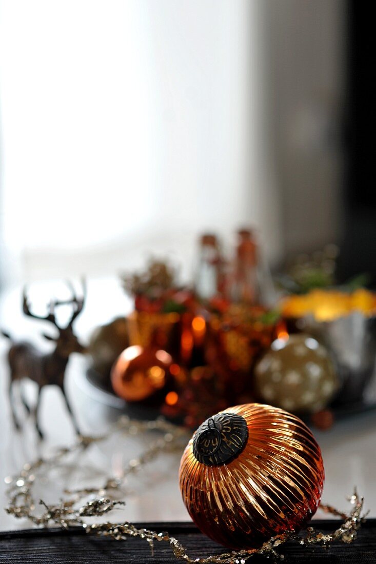 Festive table decoration with Christmas tree baubles and stag figurine