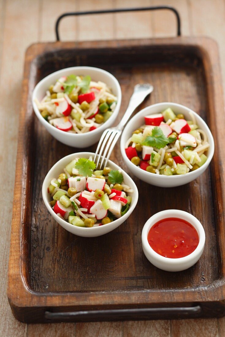 Noodle salad with surimi, cucumber, peas, coriander and chilli sauce (Asia)