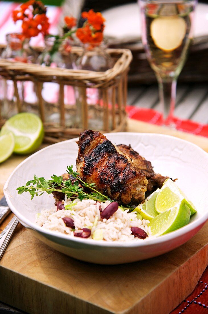 Grilled chicken with bean rice and limes