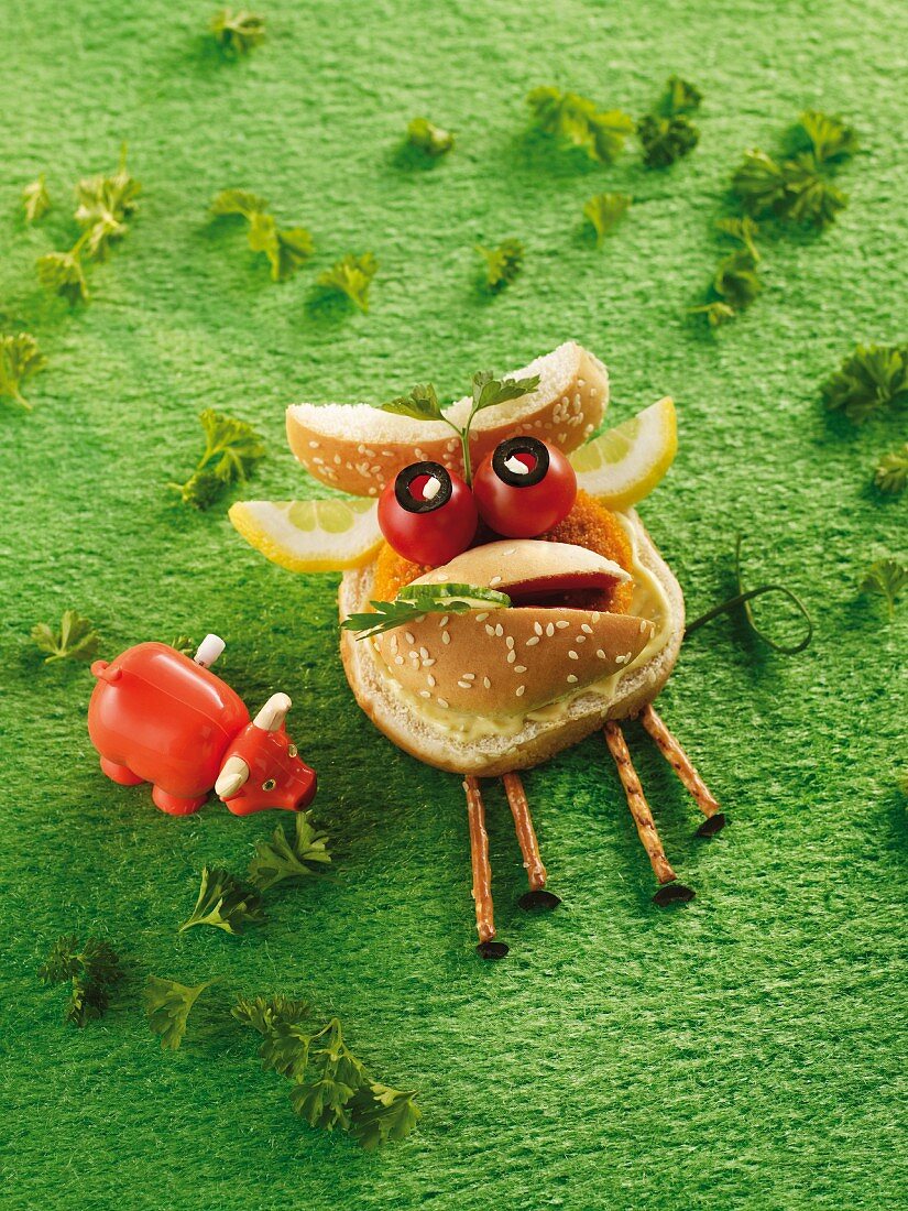 A horned ox made from a sesame seed bun, cherry tomatoes and lemon