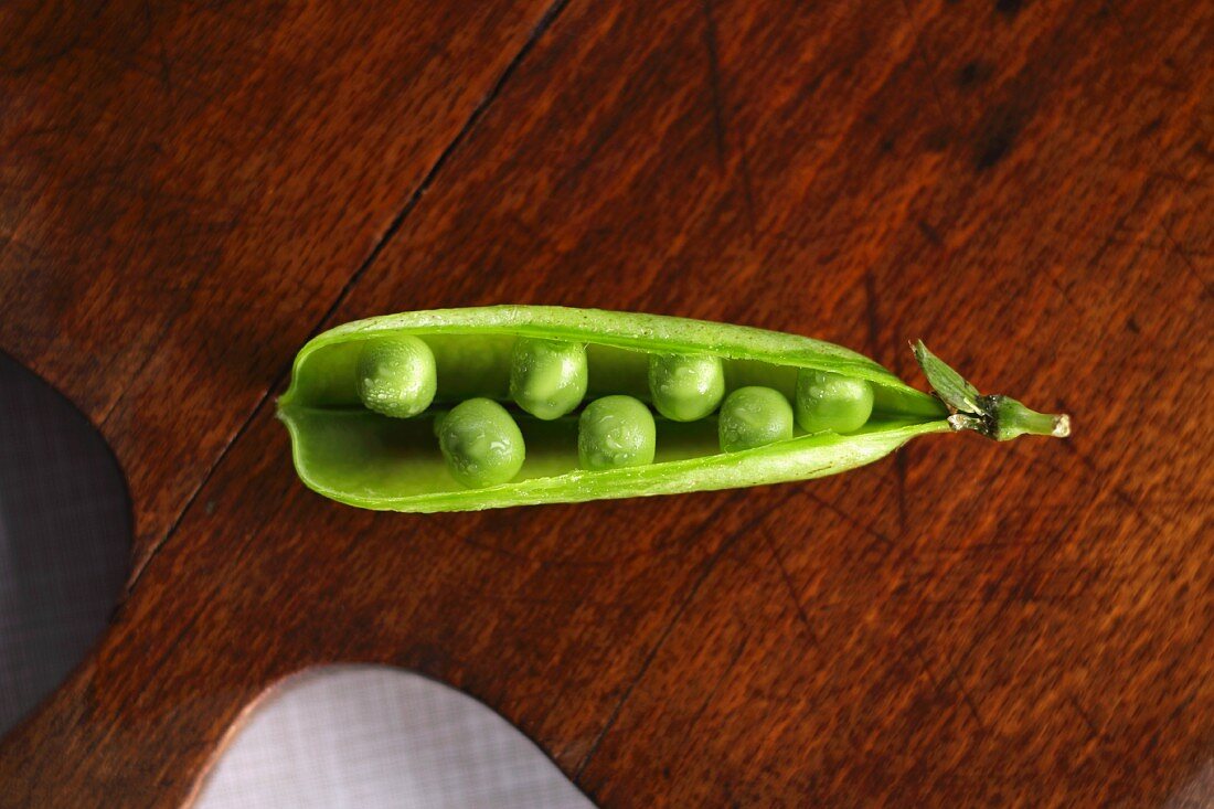 An open pea pod viewed from above