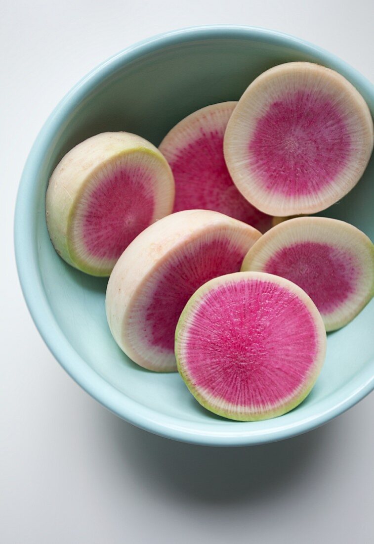 Watermelon radish, cut into slices, in a bowl