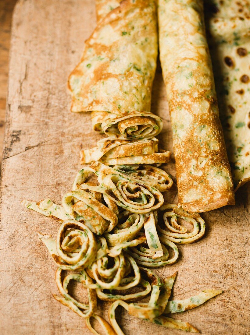 Rolled herb pancakes, partly sliced