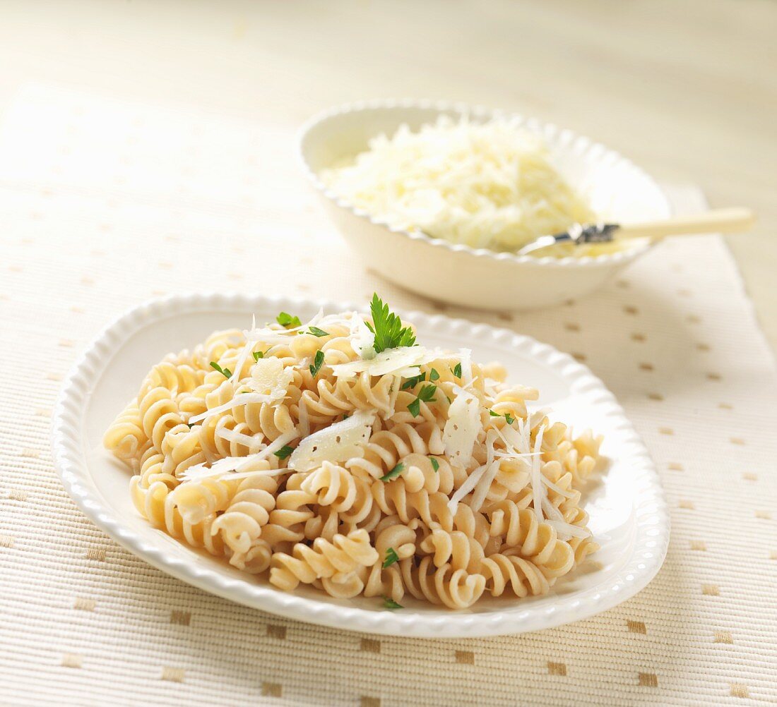 Gluten Free Rotini Pasta with Shaved Cheese on a White Dish