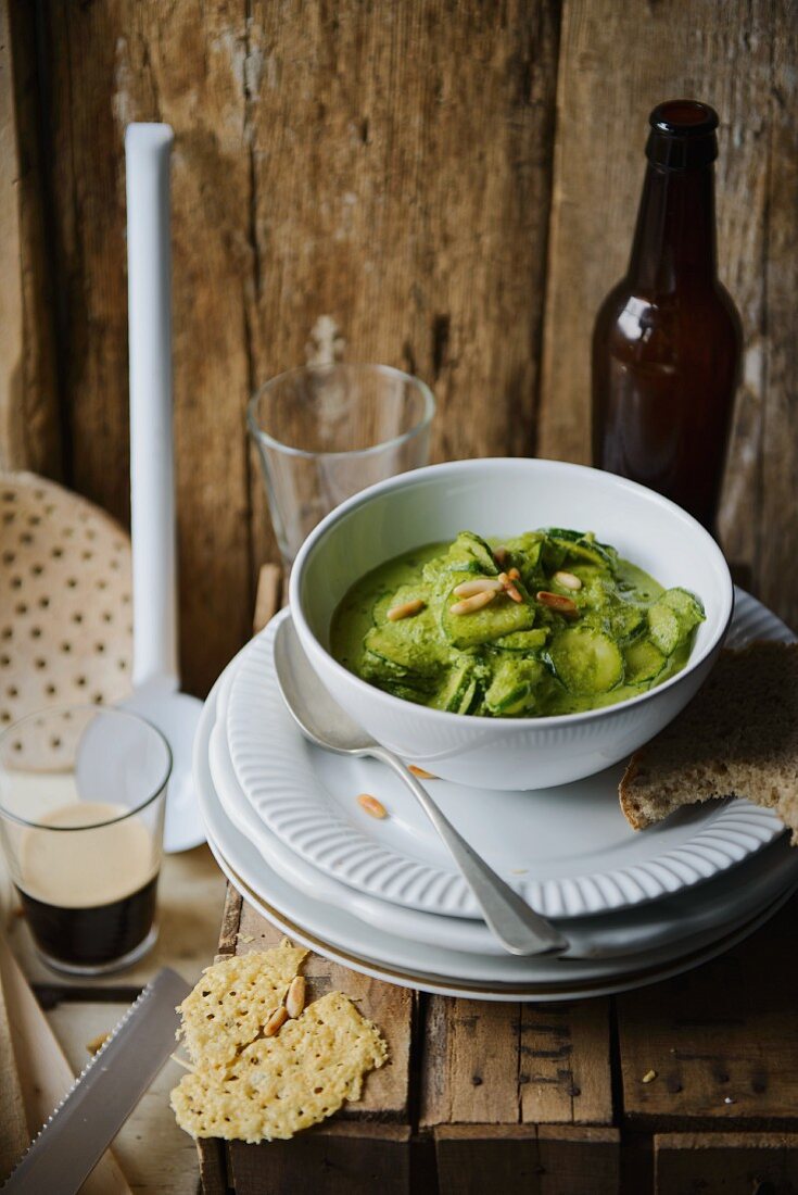 Courgette stew with pesto and pine nuts