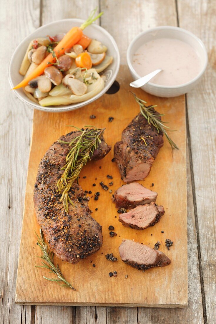 Roast fillet of venison with rosemary, vegetables and porcini mushrooms