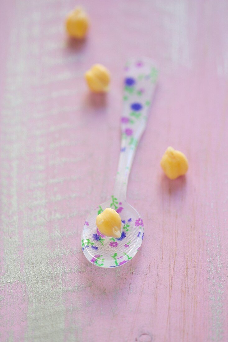 Dried chickpeas with a floral-patterned spoon