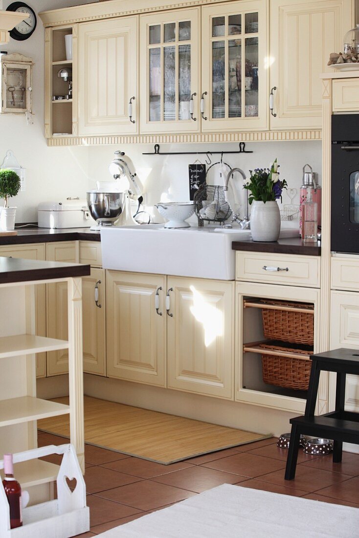 Cream fitted kitchen with panelled doors and large Belfast sink