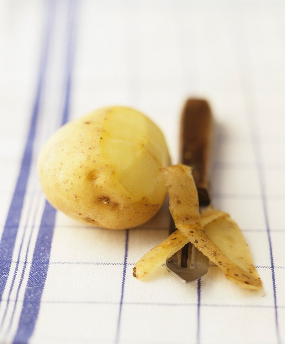 A half-peeled potato