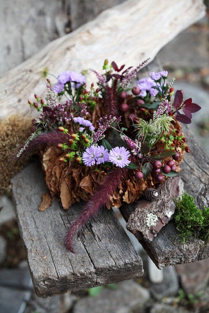 Autumnal wreath of leaves, flowers & berries