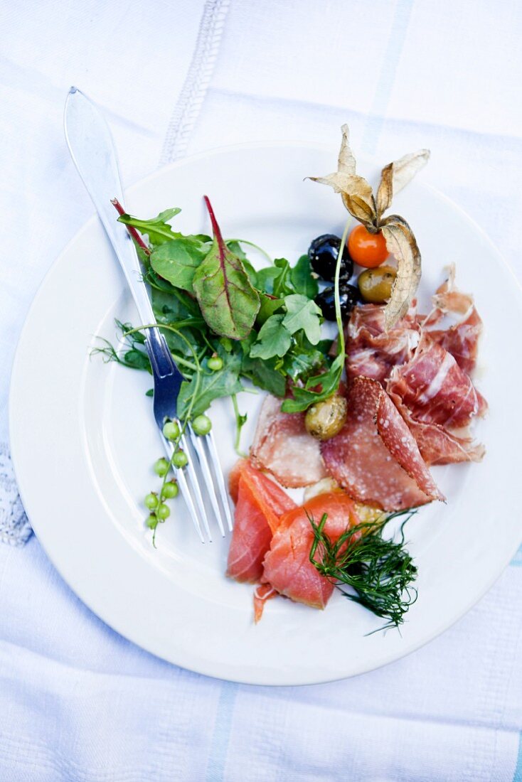 charcuterie plate, salami, prosciutto, smoked salmon, green salad