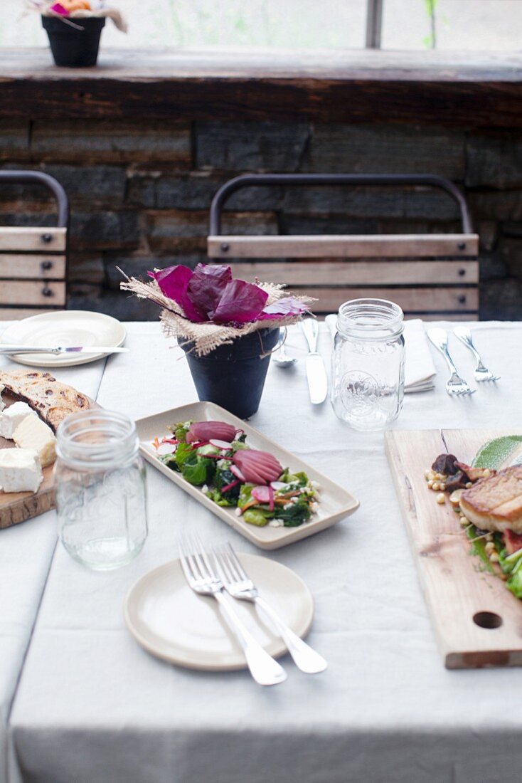 Brussels sprout salad with poached pears on a laid table