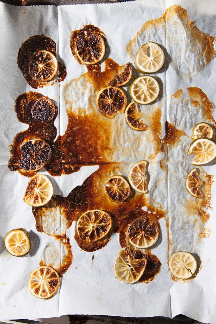 Burnt lemon slices on grease-proof paper