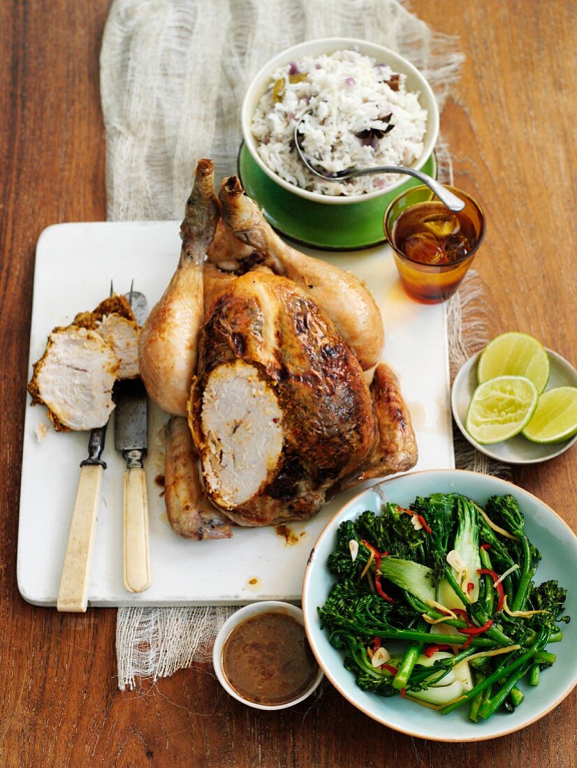 Roast chicken, partly sliced, with rice and vegetables (Thailand)