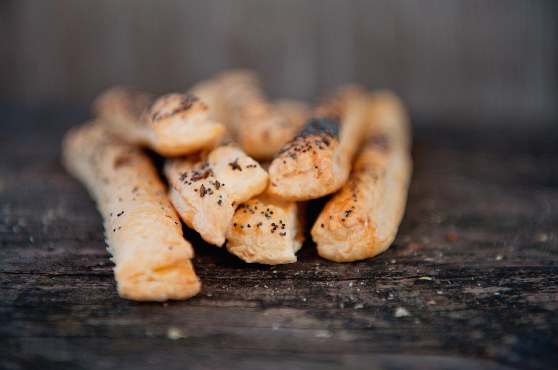 Bread sticks with poppy seeds on a wooden table