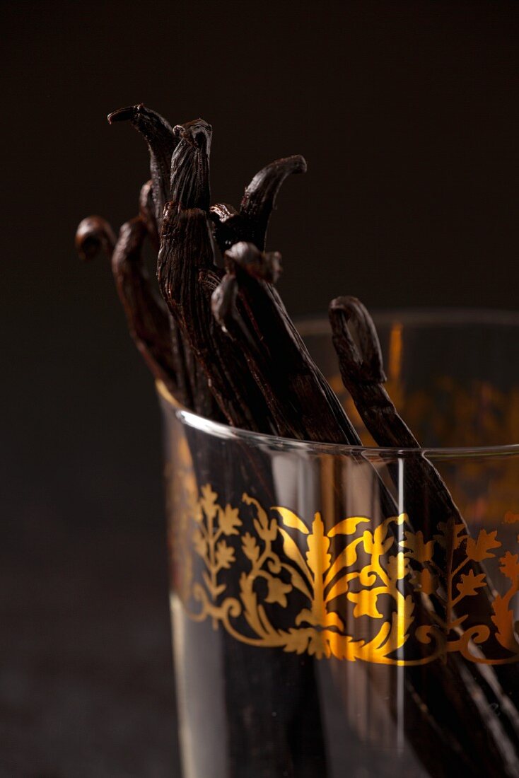 Vanilla pods in a glass with gold decoration