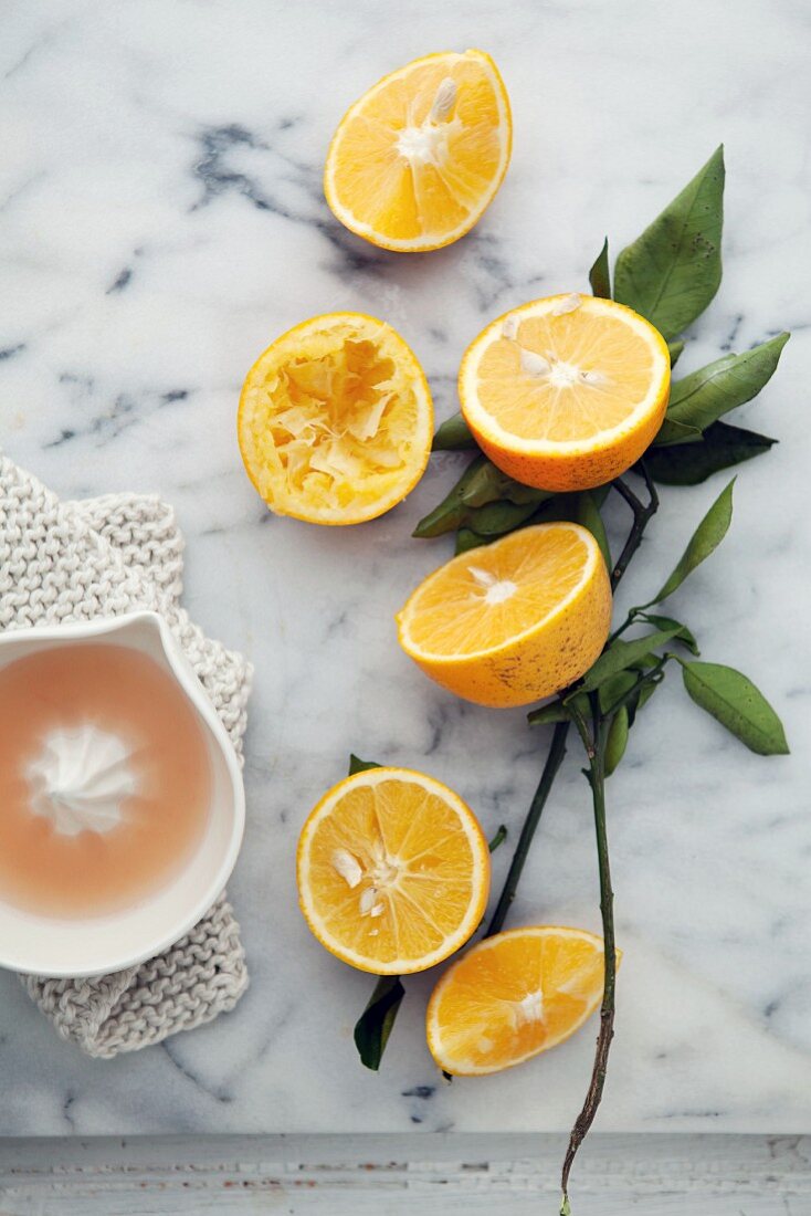 Halved oranges with a citrus squeezer