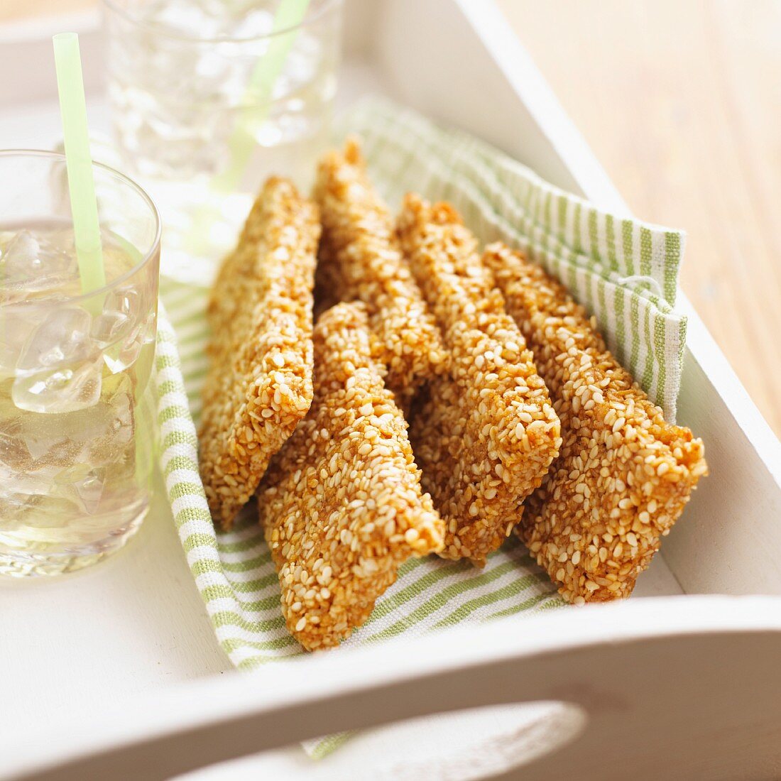 Sesame biscuits and drinks on a tray