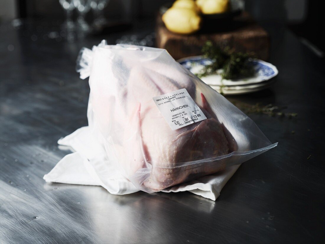 A chicken prepared for roasting, in a plastic bag