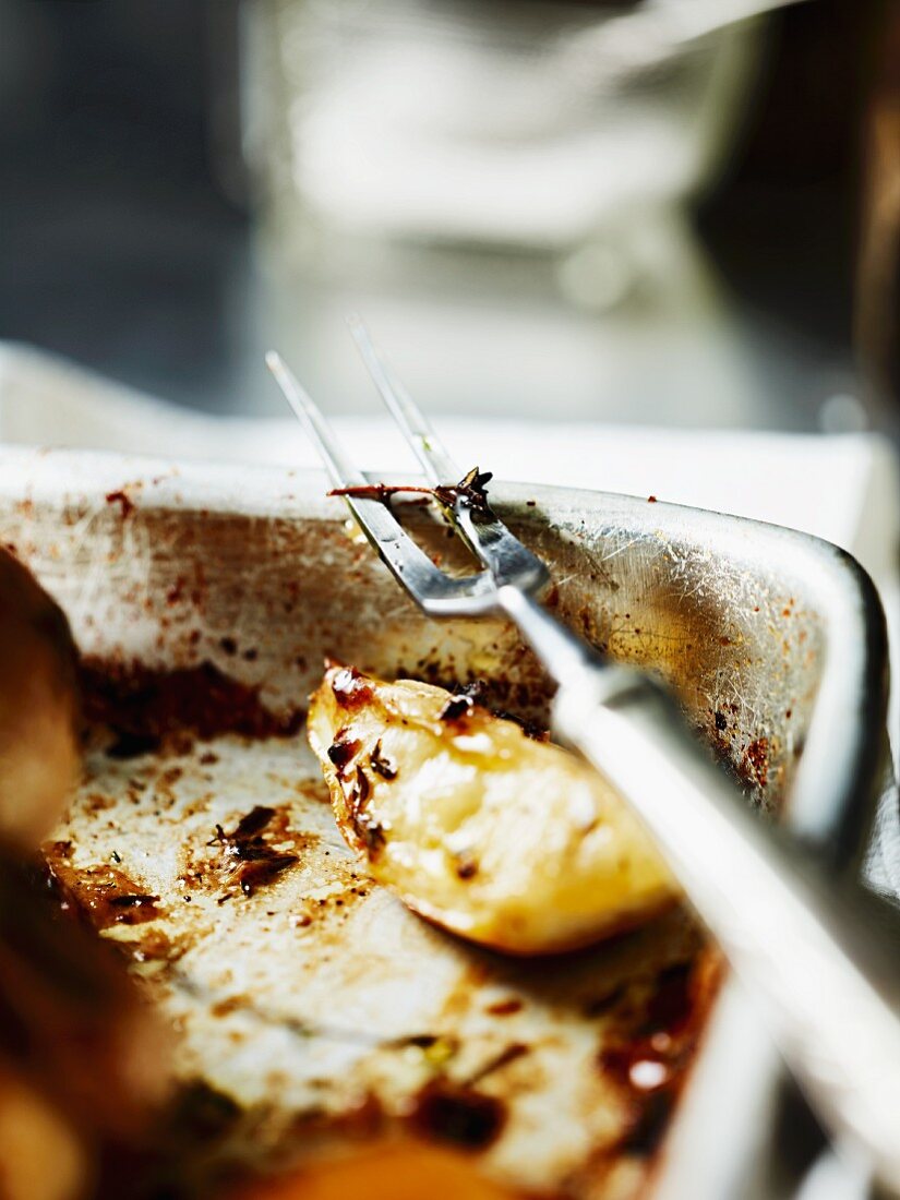 Roast chicken with lemon and a meat fork (section)